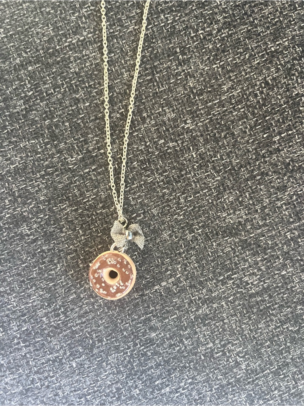 Silver Pendant Necklace with Donut Charm and Bow Accent